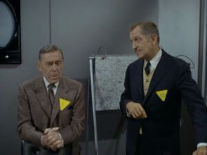 Vincent Price and Lewis Carroll sit in a grey office and get ready to chew scenery together