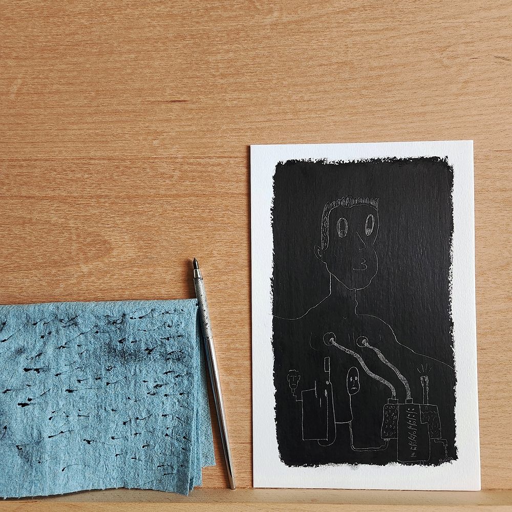 Black and White oil pastel drawing of a man hooked up to machines. The artwork is laying on a wood easel with a blue towel and an etching pen laying next to it.