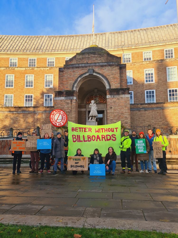 A crowd of people at a demo holding placards and banners. 