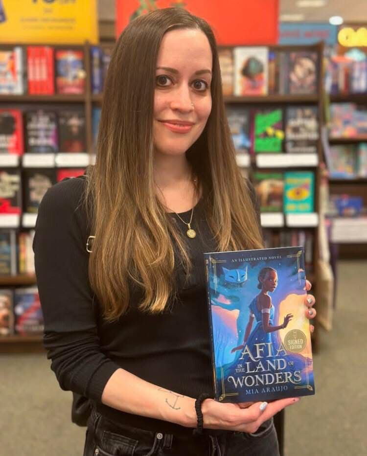 Mia Araujo with her debut book AFIA IN THE LAND OF WONDERS. 