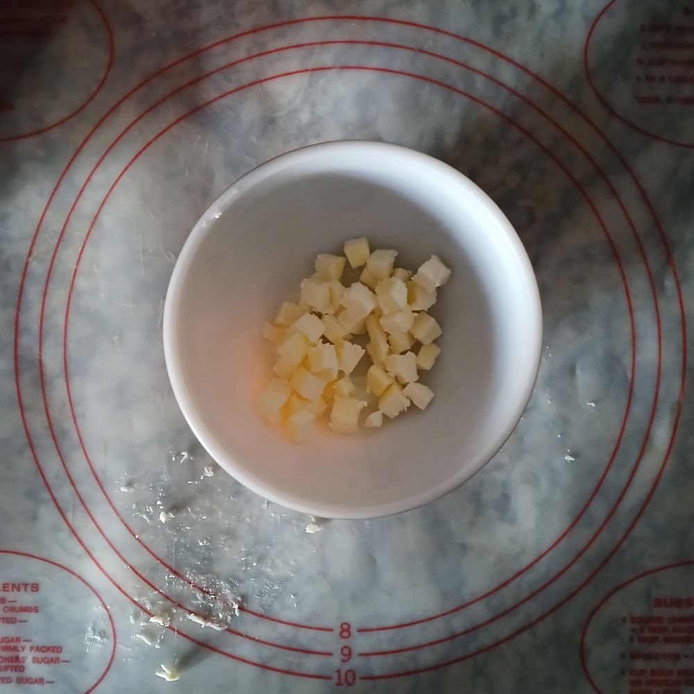 A top down view of cubed butter in a bowl.