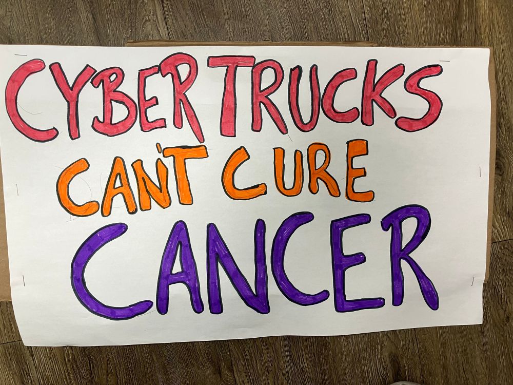 Poster saying: Cybertrucks can’t cure cancer