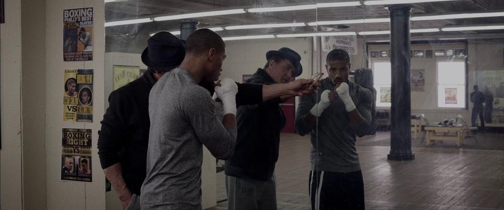 An old, Italian uncle helps to train his nephew in a boxing gym by the mirror. He's helping by pointing out who the real obstacle is to his success and gives one hell of a reminder about how fighting to win in the little moments help build to the big ones.