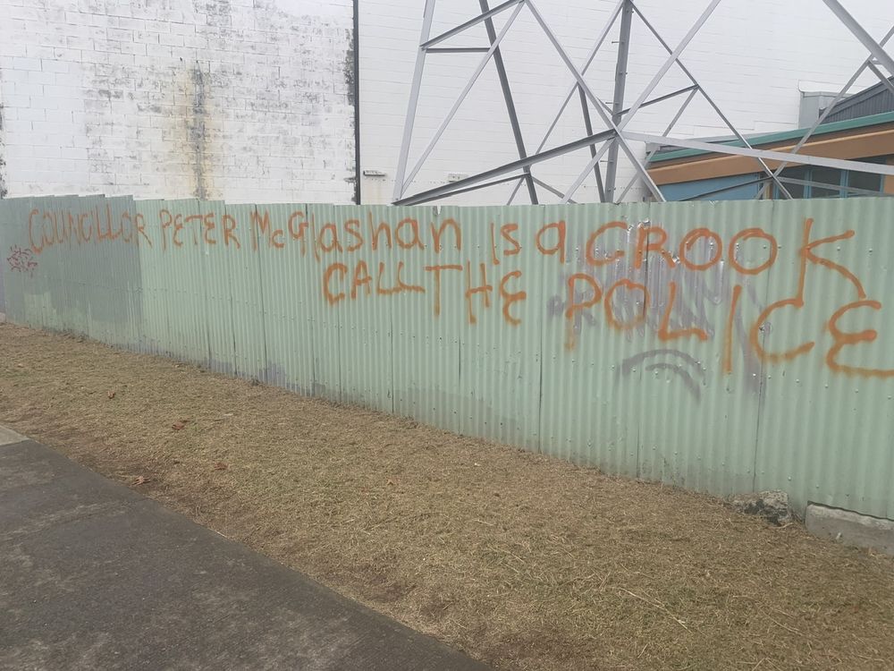 Some graffiti on a fence saying Peter McGlashan must be doing something right