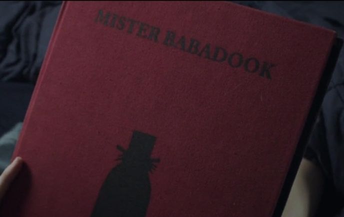 A red hardcover book titled "Mister Babadook"; underneath the title is a black silhouette of the Babadook. 