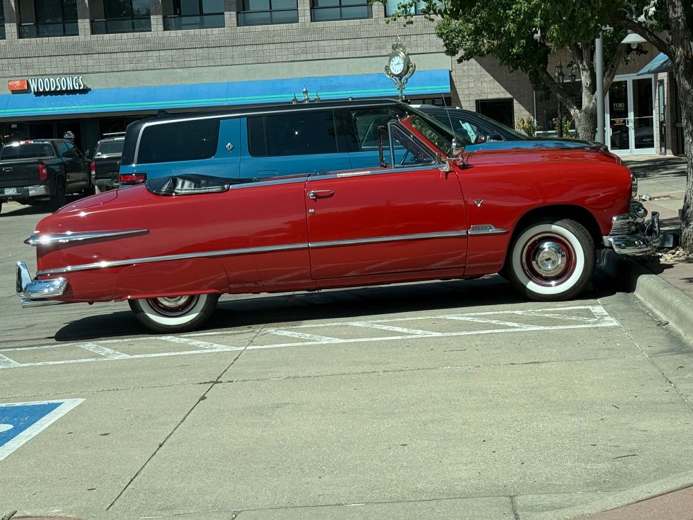 Old red convertible with white walls. Absolutely pristine. 