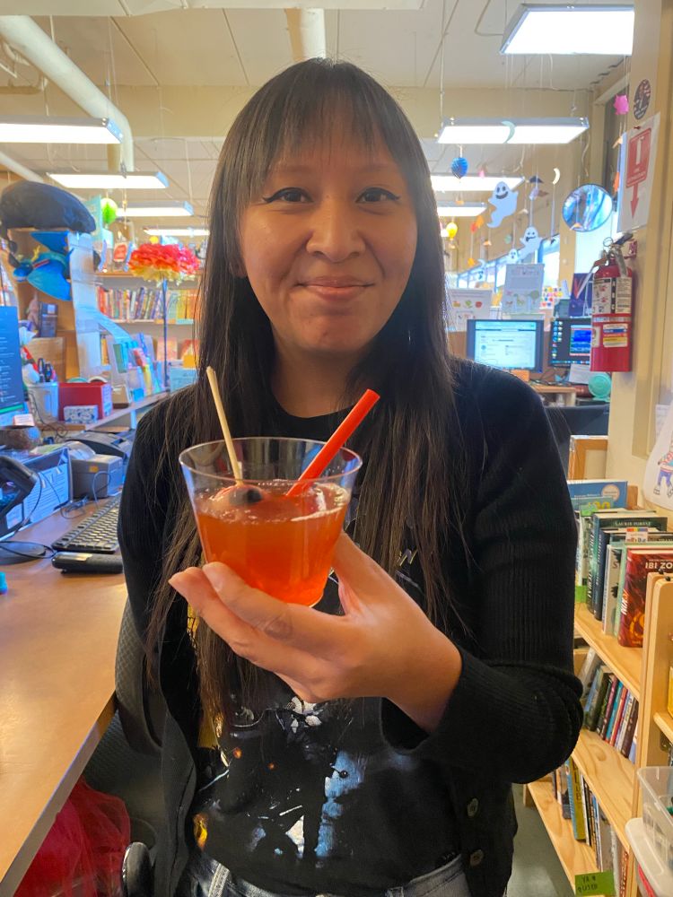 Maya holding that dingy red drink with the eyeball in it