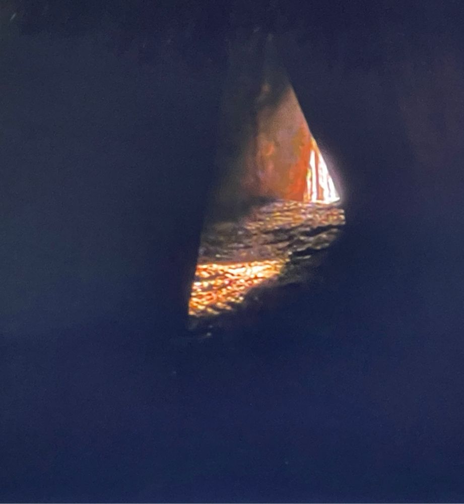 A small triangle of light amidst the darkness as the sun enters the passage grave of Newgrange on the Winter Solstice.