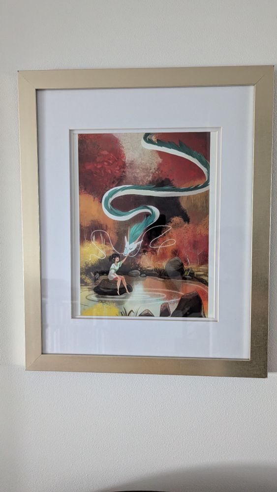 Chihiro and Haku rest at a still point in the river. Rendered in oranges and blues.