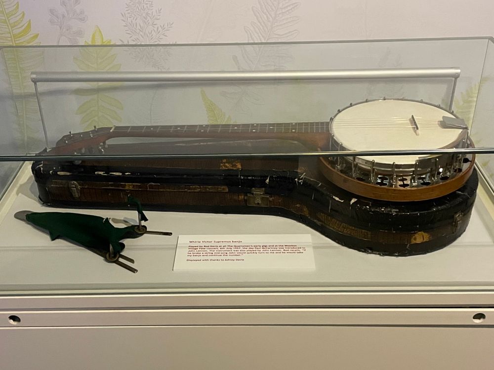 Five string banjo in display case at Strawberry Fields