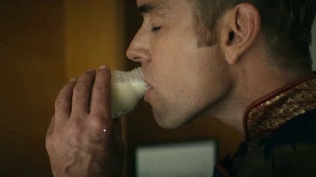 a man is drinking milk from a bottle with a label that says ' milk ' on it