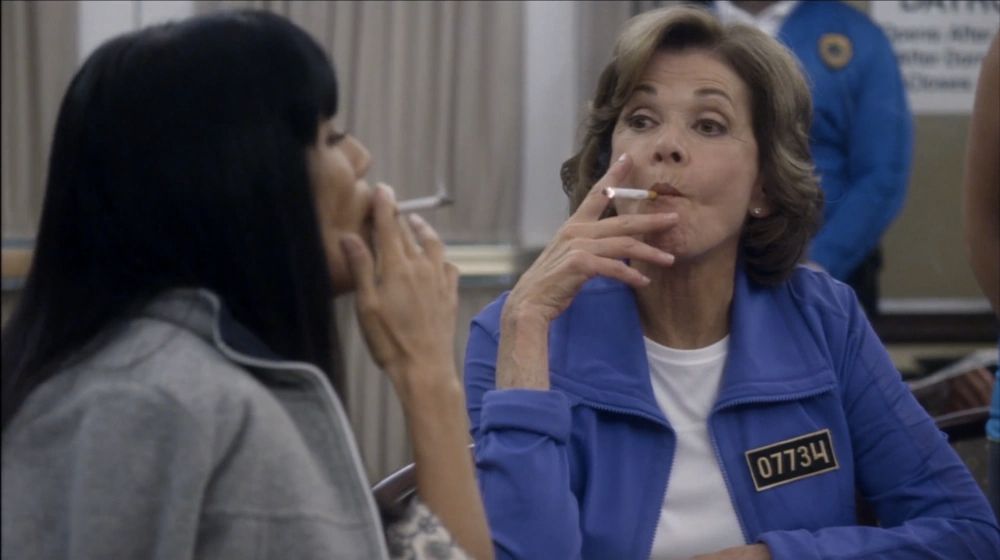Arrested Development S4. Lucille smoking cigarette with Jade Dragon Triad