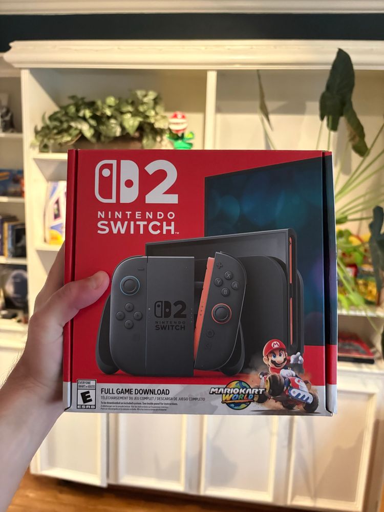 Holding up an unopened Switch 2 box