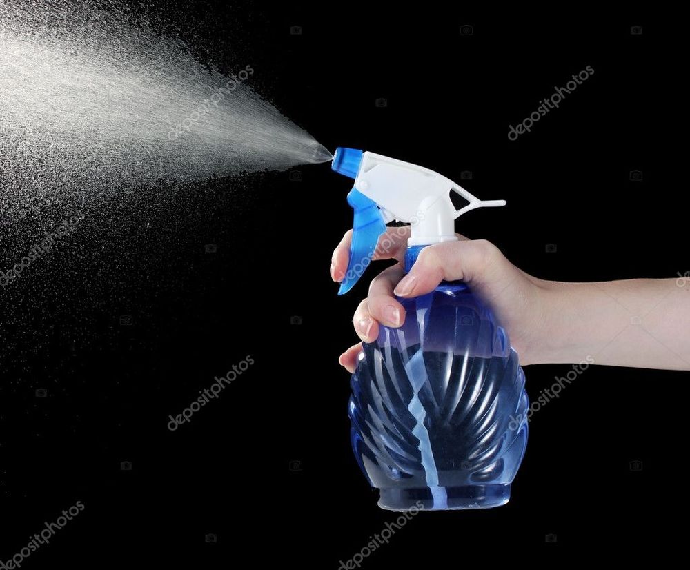 stock photo of a spray bottle of water being sprayed