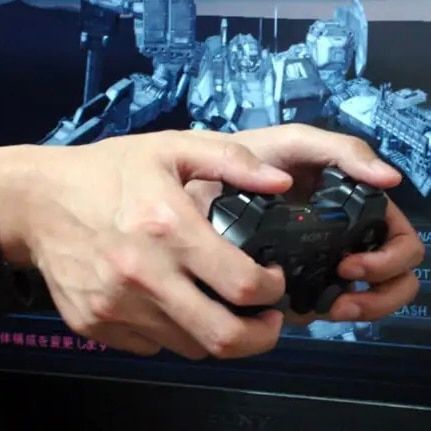 hands holding a ps2 controller backwards for the armored core reverse grip