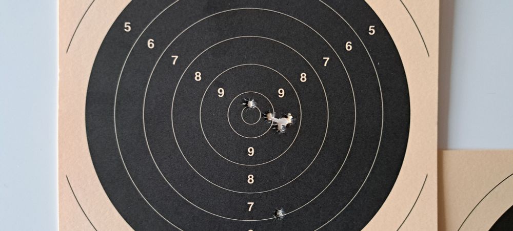 A target with a close grouping of 4 to the right of the center 