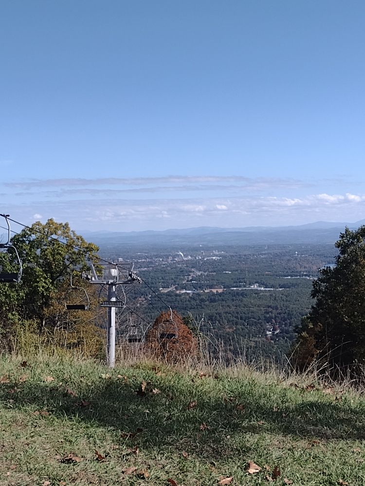 A view south from the top of West Mountain, just south of Lake George. Pale blue mountains fade into the distance under a clear blue sky.