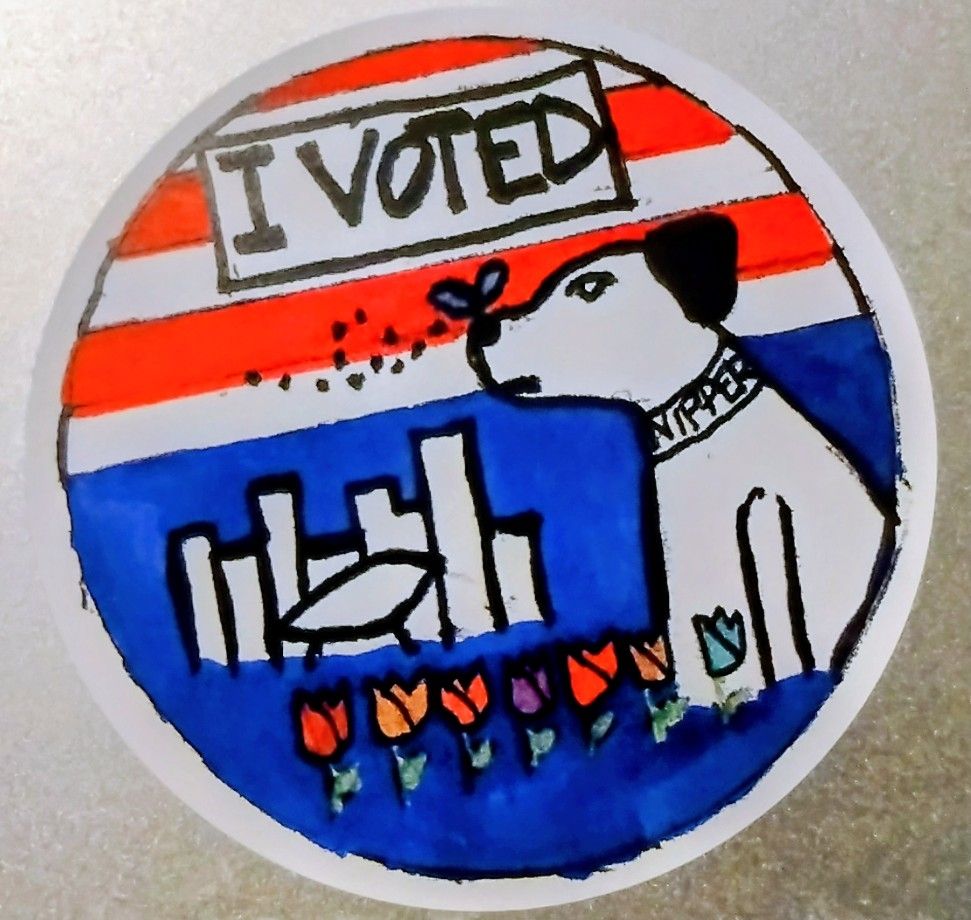 The sticker handed out at this year's polling places that say "I voted" depicting a hand drawn image of Nipper the RCA dog with a Karner Blue butterfly on his nose. He is sitting next to a hand drawn depiction of the Empire State Plaza and a row of tulips is in front of them all.