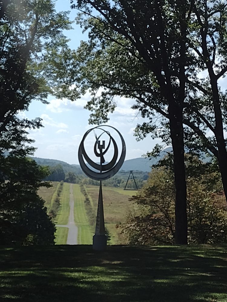 A circular sculpture atop a narrowing pillar overlooking another section of the park. Because the whole damn park is hills.