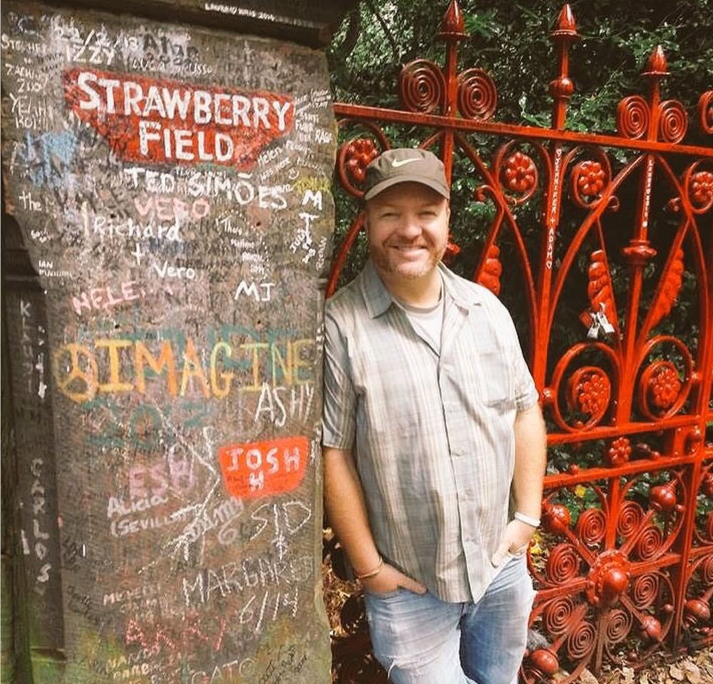 A picture of me standing by the famous strawberry fields gates in Liverpool 
