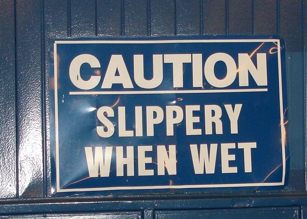Sign from the old Yankee Stadium reading CAUTION - SLIPPERY WHEN WET