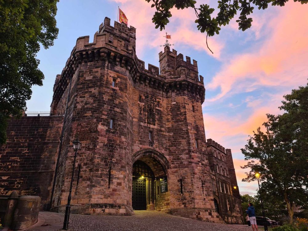 Image shows the entrance of Lancaster Castle at sunset.