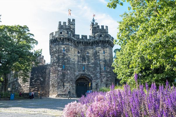 Image shows the entrance of Lancaster Castle in spring.