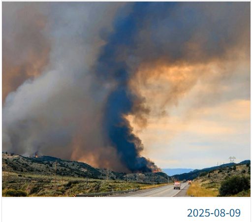 large fire's smoke column is mostly white with black on the right side.
