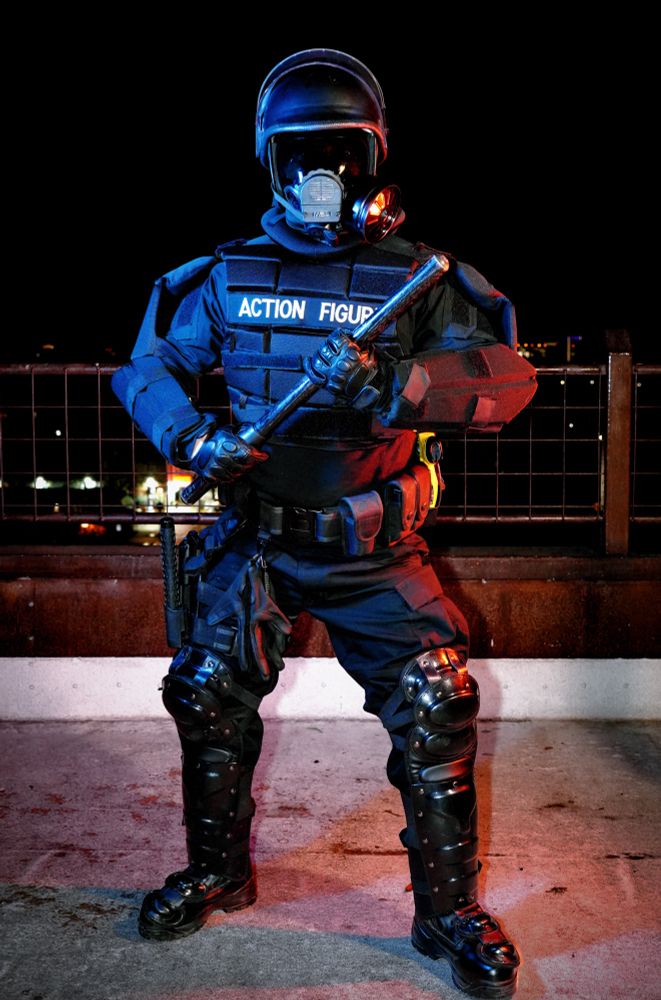 Man in full riot gear holding a baton