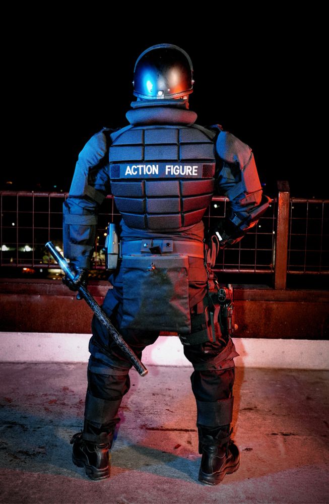 Man in riot gear from behind 