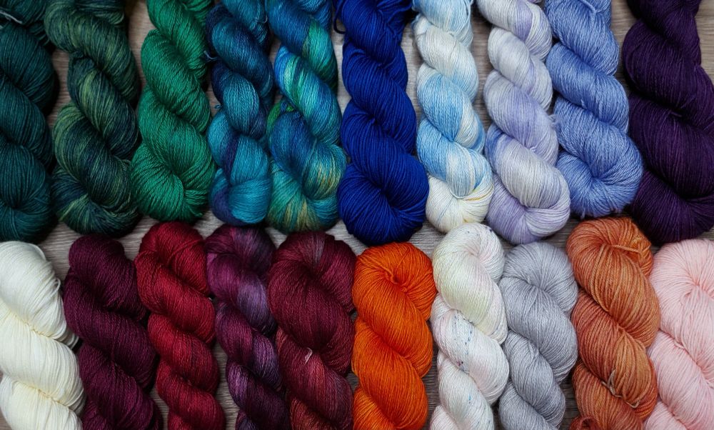 2 rows of colorful coiled skeins of yarn 