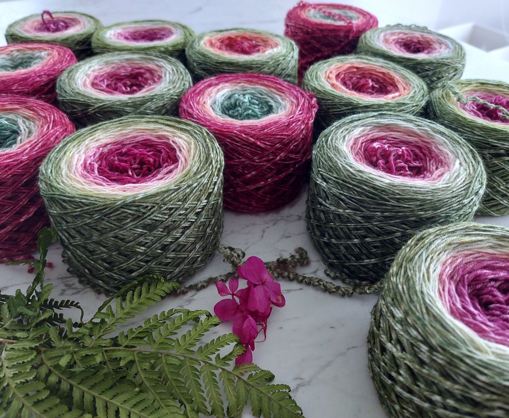 A bunch of yarn cakes and fern leaves 