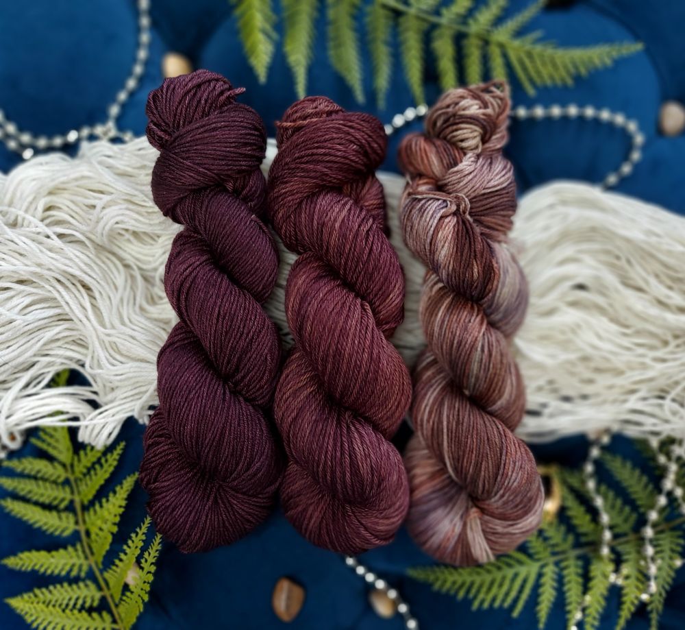 3 skeins of brown shades on a bed of cream yarn (elegant eggshell). There are leaves and beads scattered around 

From L to R: cocoa sepia gaze, Dom Miguel Oak Brown and Rustic-Earth Archer 