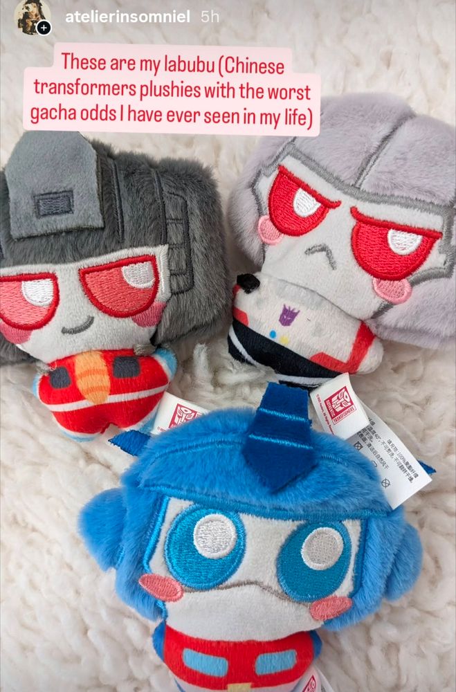 Photo of small Starscream, Megatron and Optimus Prime plushies with huge eyes and blushing cheeks 
