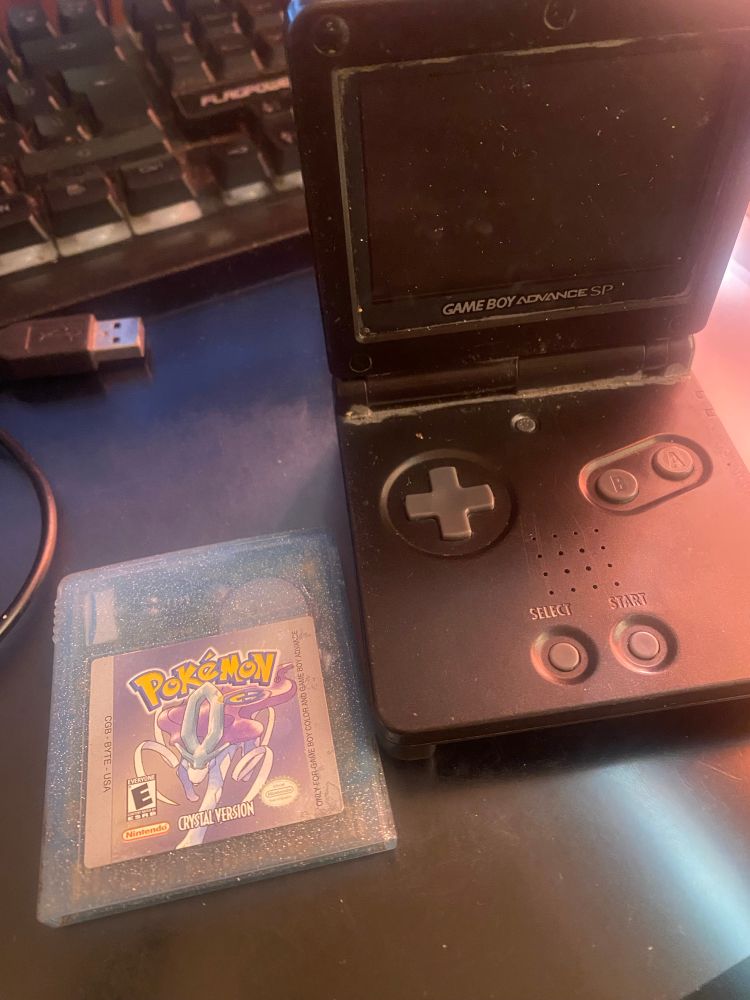 Found my old Gameboy SP that turns on (but no longer works) with my Pokémon Crystal Gameboy cartridge in good condition! 