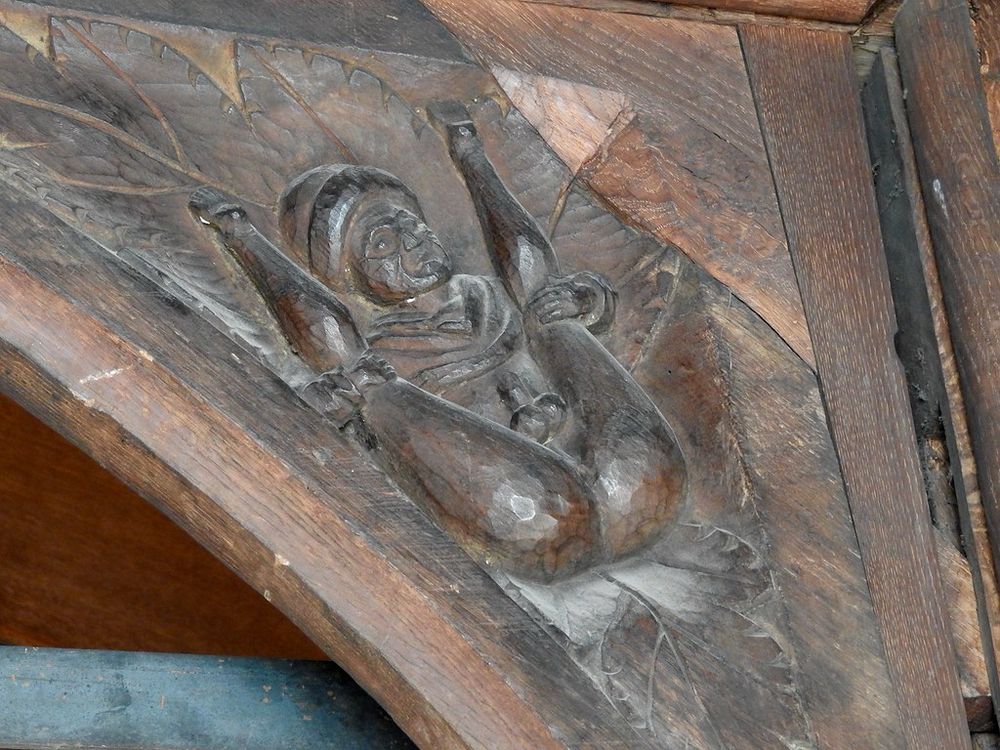 800 yr old carved drawing of a robed man exposing his cock and balls while legs are spread back exposed during renovation at All Saints Church in Hereford, England