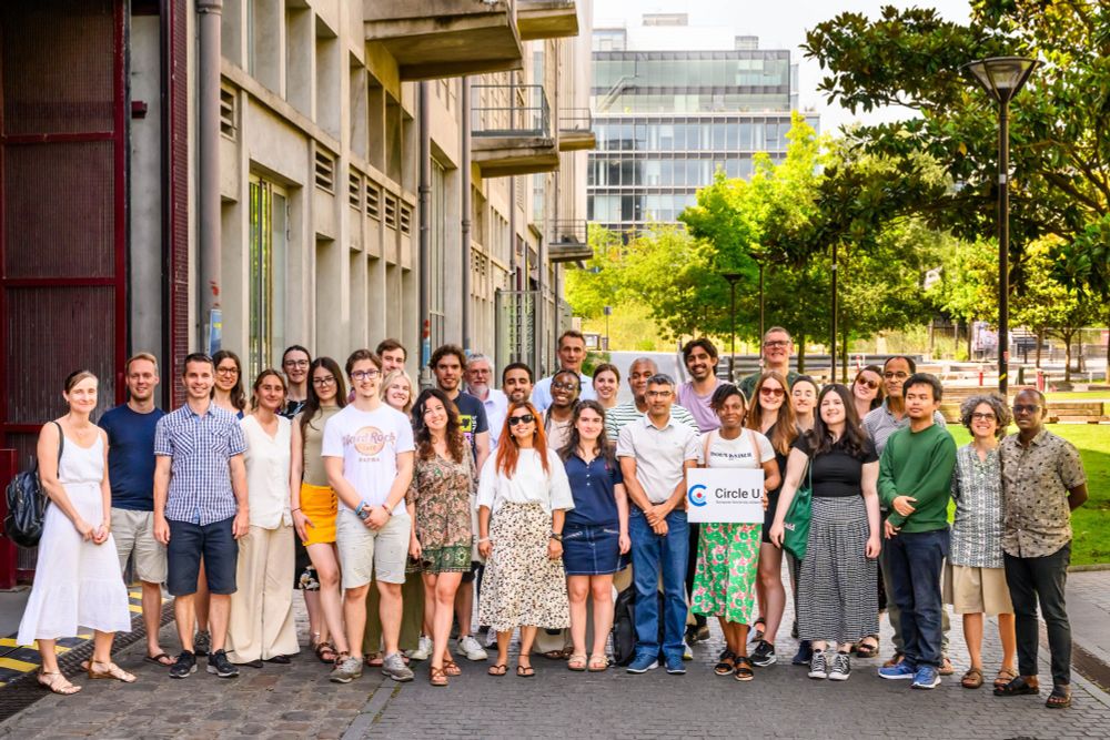 Group of 25 people smiling at the camera outdoors