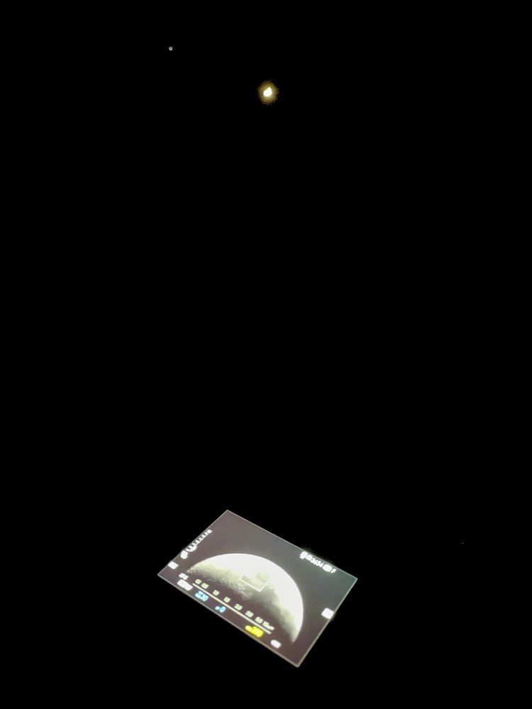 wide angle phone image of the moon and a telescope mounted camera imaging the moon 