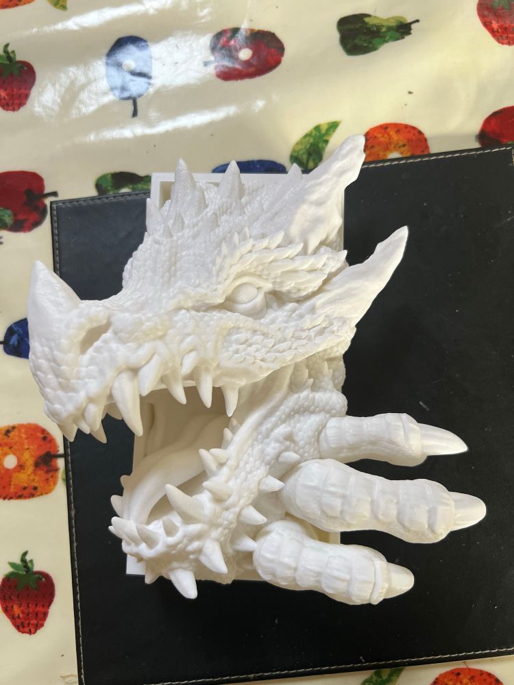 Picture shows an FDM printed dragon book end the dragon is roaring and grabbing with its claws. Rawr.