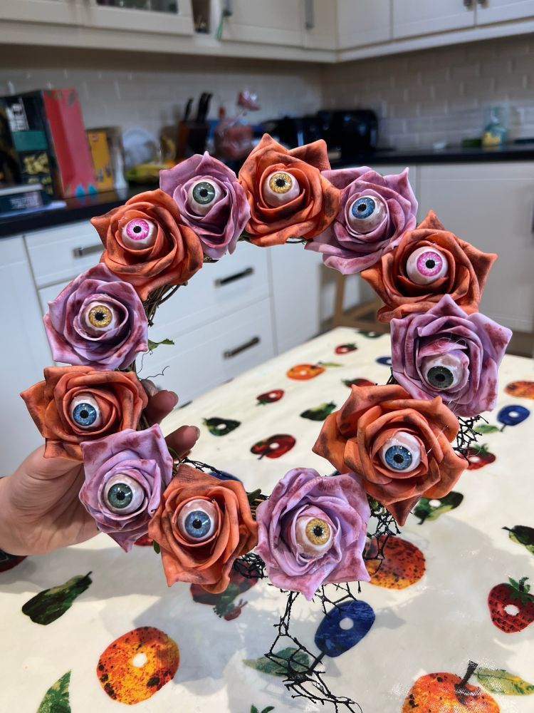 Be not afraid, this picture shows a wreath of blood stained roses where the centre of each flower is an eye. It’s pretty creepy.