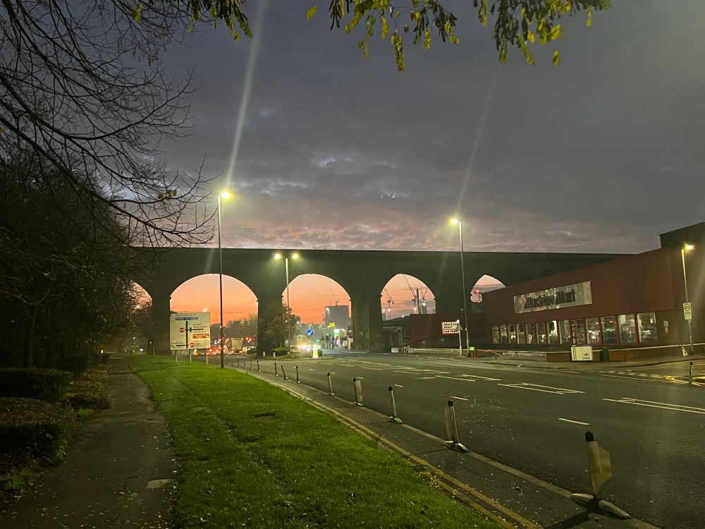 Picture shows the sun starting to rise under the railway bridge on the A65