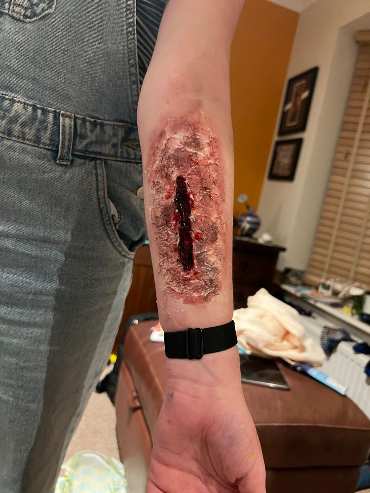 Picture shows a grizzly looking fake wound.