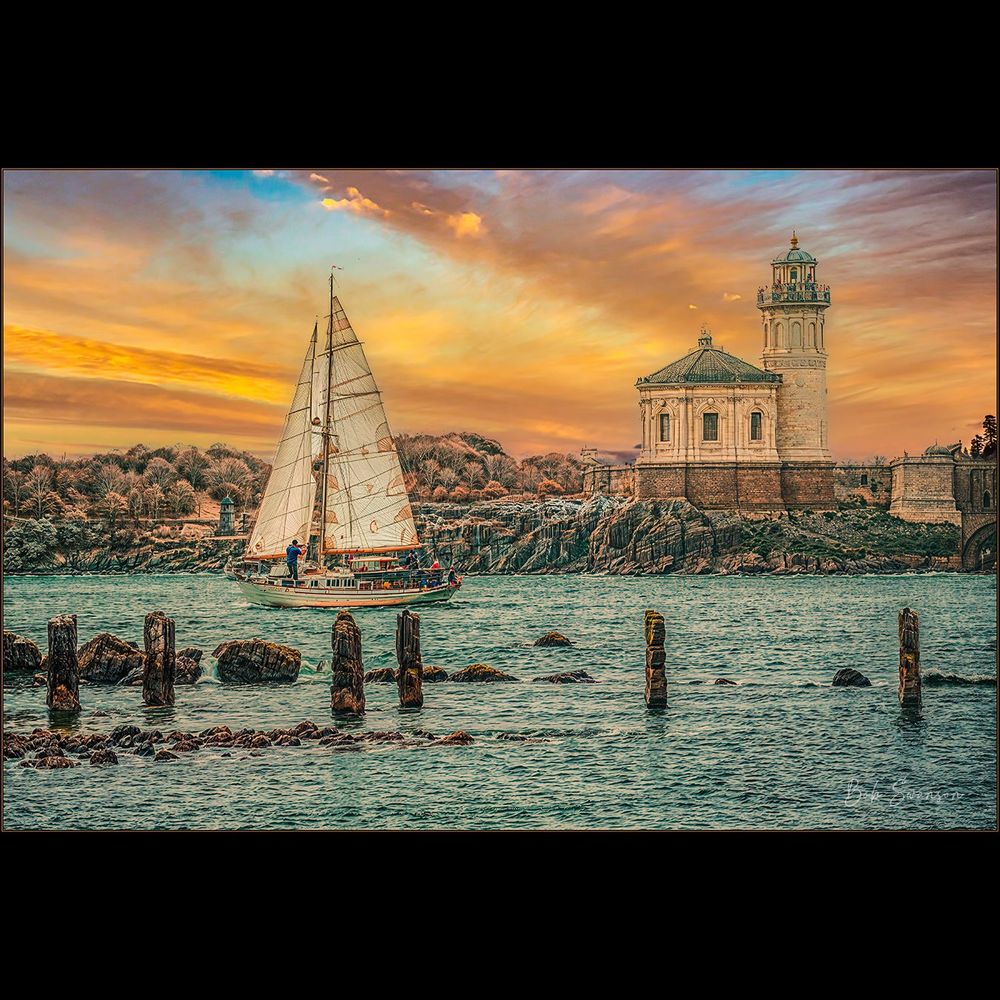 Sailboat going to sea in front of historic lighthouse at Bandon, Oregon ar sunset. Made with ai help.