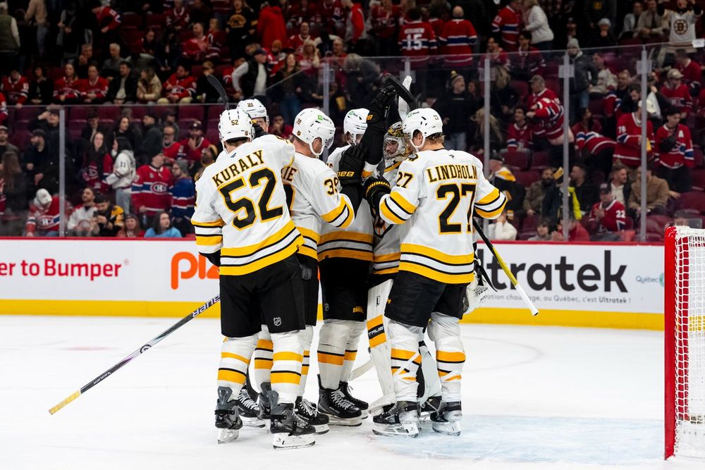 Sean Kuraly, Morgan Geekie, Hampus Lindholm, Nikita Zadorov and David Pastrnak surround Jeremy Swayman following the B's win in Montreal.
