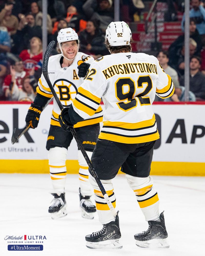 David Pastrnak smiles as he goes to celebrate with Marat Khusnutdinov.