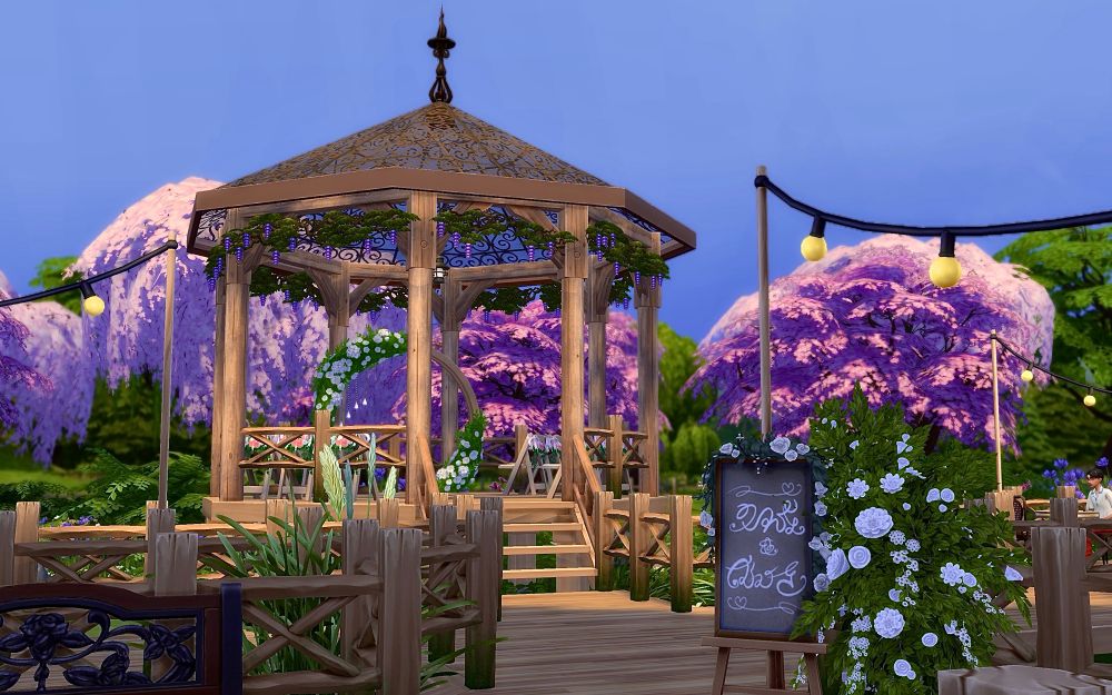 in sims 4: wedding gazebo on a pier over a swamp, in the foreground in a sign in simlish for the couple and a large bouquet of white cascading flowers. the gazebo is up a set of stairs and has a ornate glass roof, there are a few rows of chair and a circular arch with white flowers wrapped around it