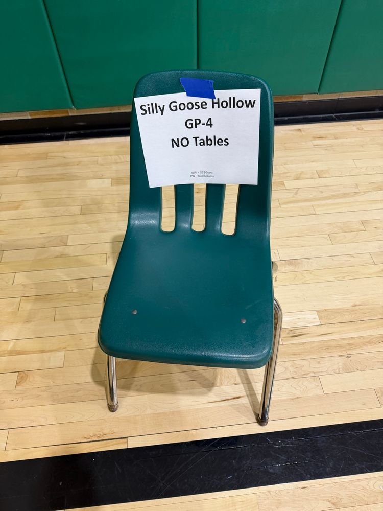 Plastic chair with a paper sign taped on it. The sign says:

Silly Goose Hollow

GP-4

NO Tables