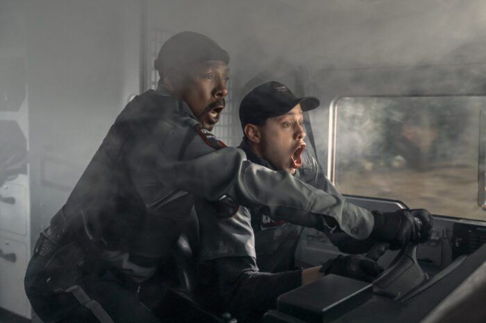 Russell and Travis in the front seat of their armored vehicle in The Pickup.