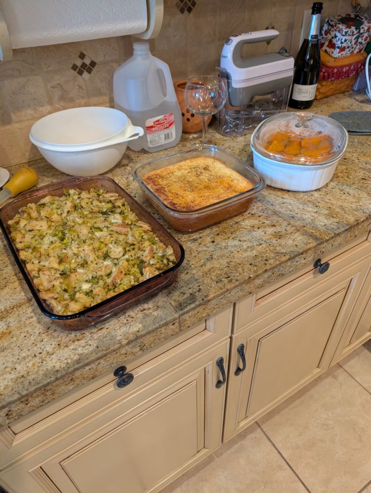 More Thanksgiving food. A dish of stuffing, corn casserole and escaloped sweet potatoes and apple. 