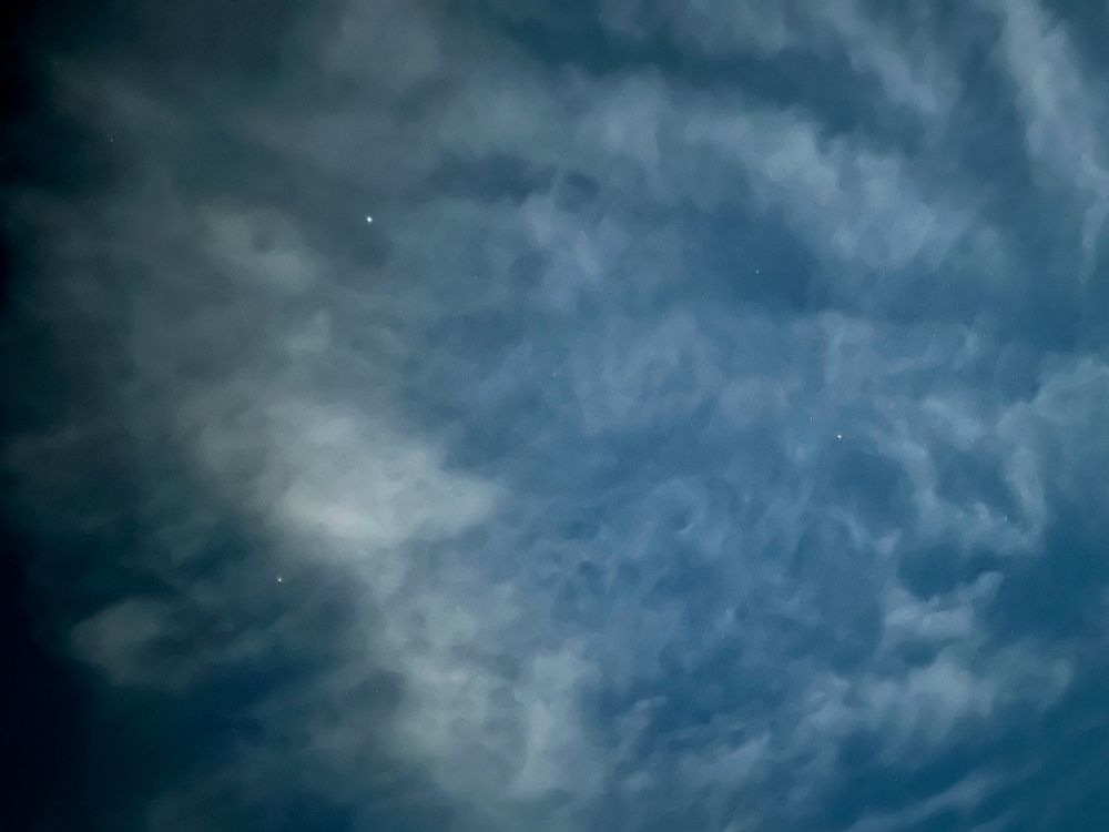 iPhone photo of the “Summer Triangle” asterism peeking through some moderate cloud cover. 